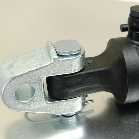 Close-up of a metal and rubber automotive part, specifically a Hydraulic Top Link (Cat.3/3) Knuckle and Q.R CBM Hook from Sparex, placed on a reflective surface—suitable for tractors.