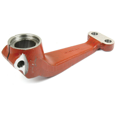 The Sparex Steering Arm (2WD), Part No. S.40121, is a red metal component featuring a circular gear socket on one end and two bolt holes on the other. The surface exhibits minor wear and tear, typical for Massey Ferguson machinery parts.