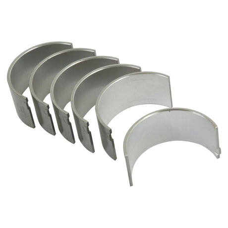 Six Conrod Bearing +0.030'' (0.75mm) sets, compatible with Massey Ferguson and branded by Sparex, neatly arranged in a slightly curved line, showcasing their semi-circular shape and metallic luster against a plain white background.