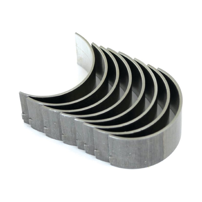 A set of eight conrod bearings, perfect for Ford New Holland or Massey Ferguson vehicles, arranged in a stack with each bearing featuring a semi-circular shape and a smooth interior surface. This Conrod Bearing Std. Set is available under Sparex Part No.S.40319 from the trusted brand Sparex.