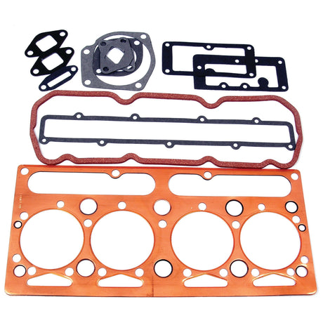 A collection of various engine gaskets, including a Perkins head gasket, a large multi-hole gasket, a rectangular gasket, and several smaller gaskets of different shapes and sizes is available as the Top Gasket Set - 4 Cyl. (AD4.203) from Sparex (Part No. S.40592).