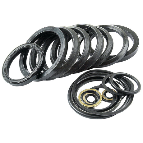 A collection of black rubber seals and gaskets of varying sizes, including the Sparex Seal Kit (Bucket Tilt Ram) | Sparex Part No.S.41274, compatible with the Massey Ferguson 50B Bucket Tilt Ram, arranged in a semi-circle with a few smaller ones placed in the foreground.