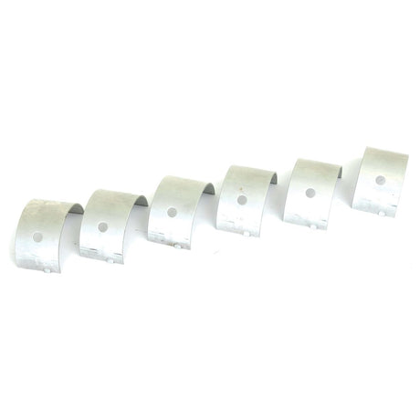 Six identical Sparex Main Bearing +0.020'' (0.50mm) metal brackets (Sparex Part No.S.42364) arranged in a diagonal line, each containing a single round hole in the center, ideal for fitting on Massey Ferguson equipment.