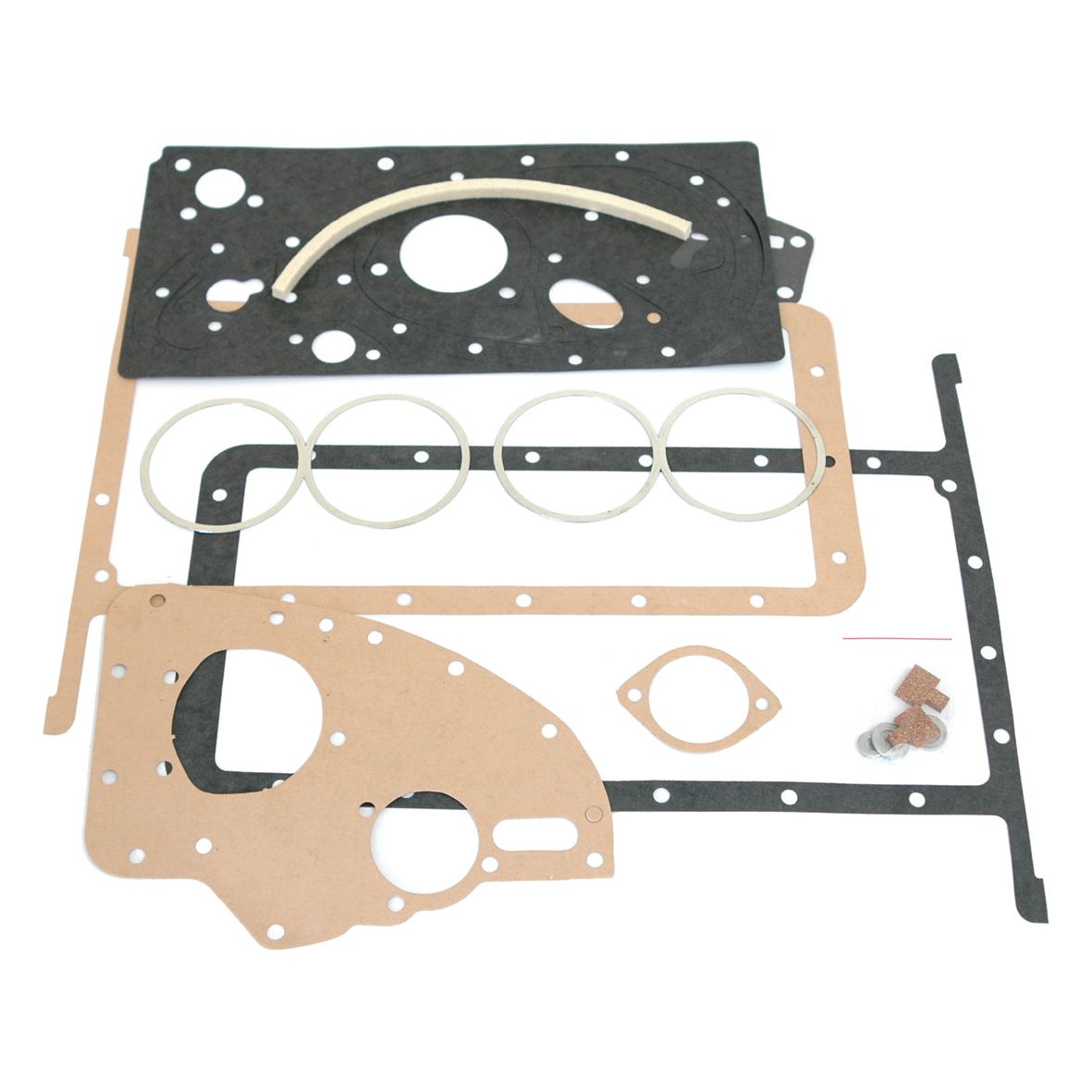 A collection of various gaskets and seals, including black, brown, and white pieces in different shapes and sizes, laid out on a white background. Perfect for Perkins Engine repairs or maintaining your Massey Ferguson equipment with dependable Sparex quality. Discover the reliability of the Bottom Gasket Set - 4 Cyl. (85mm-Petrol, 85mm-VO) | Sparex Part No.S.42631 from Sparex.