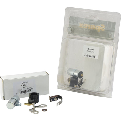 Two packaged automotive tune-up kits—one labeled as "Ignition Kit - S.42733" from Sparex, available in a blister pack and the other in a white box—are displayed alongside various small parts, connectors, and fasteners from the brand Sparex.