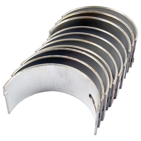 The Sparex Main Bearing Std. (Set), Sparex Part No.S.42918, consists of eight half-circle metal engine bearings arranged in an overlapping stack, ideal for Massey Ferguson models.