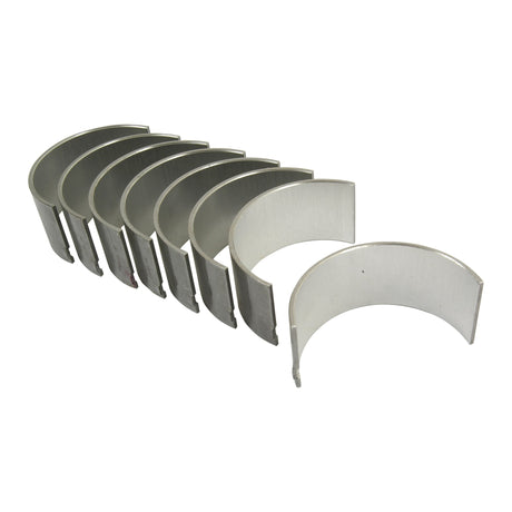 A set of seven semi-circular metal engine bearings, identified as the Conrod Bearing +0.010'' (0.25mm) Set (Sparex Part No.S.42923) by Sparex, compatible with Massey Ferguson and Perkins tractors, arranged in a line on a white background.