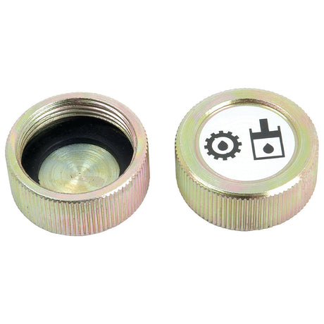 Two metal oil filler caps, one marked with an icon of a gear and an oil can, typical of the Sparex Transmission Oil Cap (Sparex Part No. S.43150) for tractors like Landini or Massey Ferguson. The other cap is turned upside down, showcasing its threaded interior.