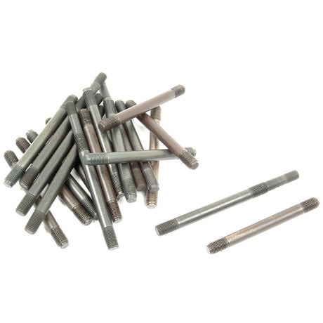 A pile of metal double-ended threaded studs from the Cylinder Head Stud Kit - S.43675 by Sparex, usually found in A3.144/A3.152 Perkins Engines, with two studs lying separately nearby on a white background.