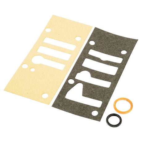 Two rectangular gaskets with various cutouts lie side by side, one beige and one black, accompanied by two small circular washers—one in copper and the other in black. This assembly could belong to a Sparex Multipower Valve Gasket Set, Sparex Part No. S.43896, suitable for machinery like the Massey Ferguson 135 or Landini 7830.