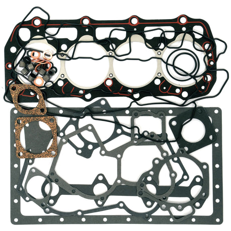 An assortment of engine gaskets and seals, including various shapes and sizes, arranged flatly on a white surface, suitable for Perkins 404C22 models. Complete Gasket Set - 4 Cyl. (404C22) | Sparex Part No.S.43912 by Sparex.