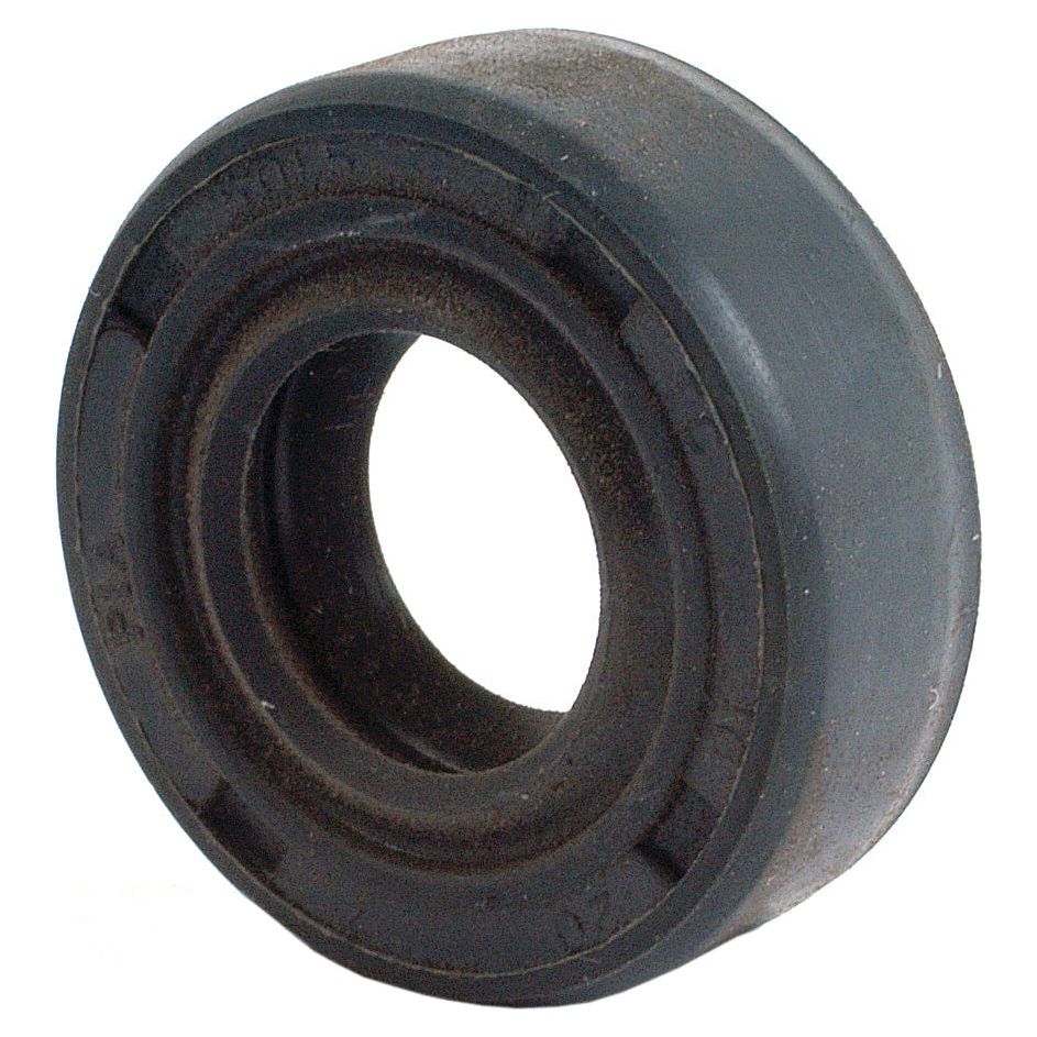 A close-up of the Sparex Metric Rotary Shaft Seal, 10 x 20 x 7mm Double Lip (Sparex Part No. S.50155), showcasing its circular opening in the center and slightly worn surface, is depicted here. This type of seal is commonly used in Universal Tractors.