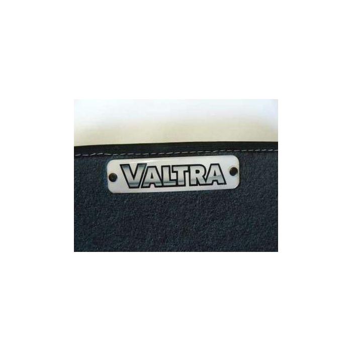Close-up of the Valtra logo on a black surface with white stitching, evoking the quality noted in the Valtra - Floor Mat - Edged Carpet Material (ACP0049730) by AGCO.