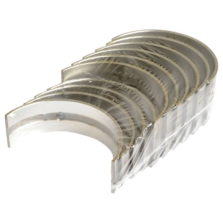 A set of Sparex Main Bearing +0.010'' (0.25mm) (Set) | Sparex Part No.S.52620, consisting of metal engine bearing shells, is arranged in a stack and partially wrapped in clear plastic packaging.