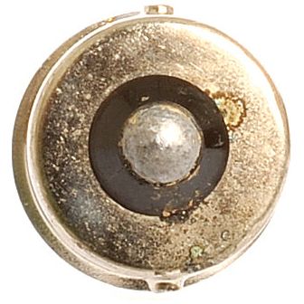 Close-up image of a vintage brass doorbell button with a central metal disk surrounded by a darker circular band. Some tarnishing and spot marks are visible on the surface, reminiscent of the patina often seen on an aged Sparex Light Bulb (Halogen) P21/5W, 12V, 5W, BAY15d.