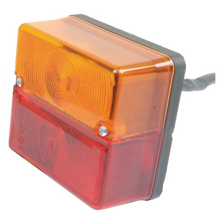 The Sparex Rear Combination Light (Halogen) for both RH and LH, designed for brake, tail, and indicator functions, features a rectangular housing with orange and red lens segments. It includes two screws on each side and a wire extending from the back. This IP65-rated light operates on 12V and is suitable for versatile vehicle lighting needs.