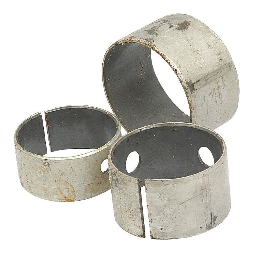 Three worn cylindrical metal sleeves from a Sparex Camshaft Bush Kit (Engine Model - S.57369, ID: Semi Finished mm), with visible scratches and holes, arranged in a scattered manner against a plain background.