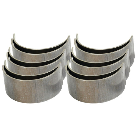 Six metal engine conrod bearings, arranged in two rows of three, each featuring a curved shape and a metallic finish. Ideal for use in International Harvester or Case IH machinery, these durable Sparex Conrod Bearing Std. Sets (Sparex Part No.S.57640) ensure reliable performance and longevity.