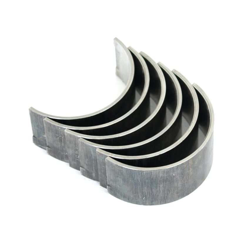 A set of five metallic semicircular engine bearings, arranged in a row with the curved sides facing upward, compatible with Case IH models.