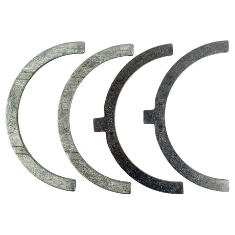 Four semi-circular metal pieces from the Sparex Thrust Bearings Set +0.25mm (Part No.S.58943), each measuring 0.25mm, are arranged in a row on a plain white background.