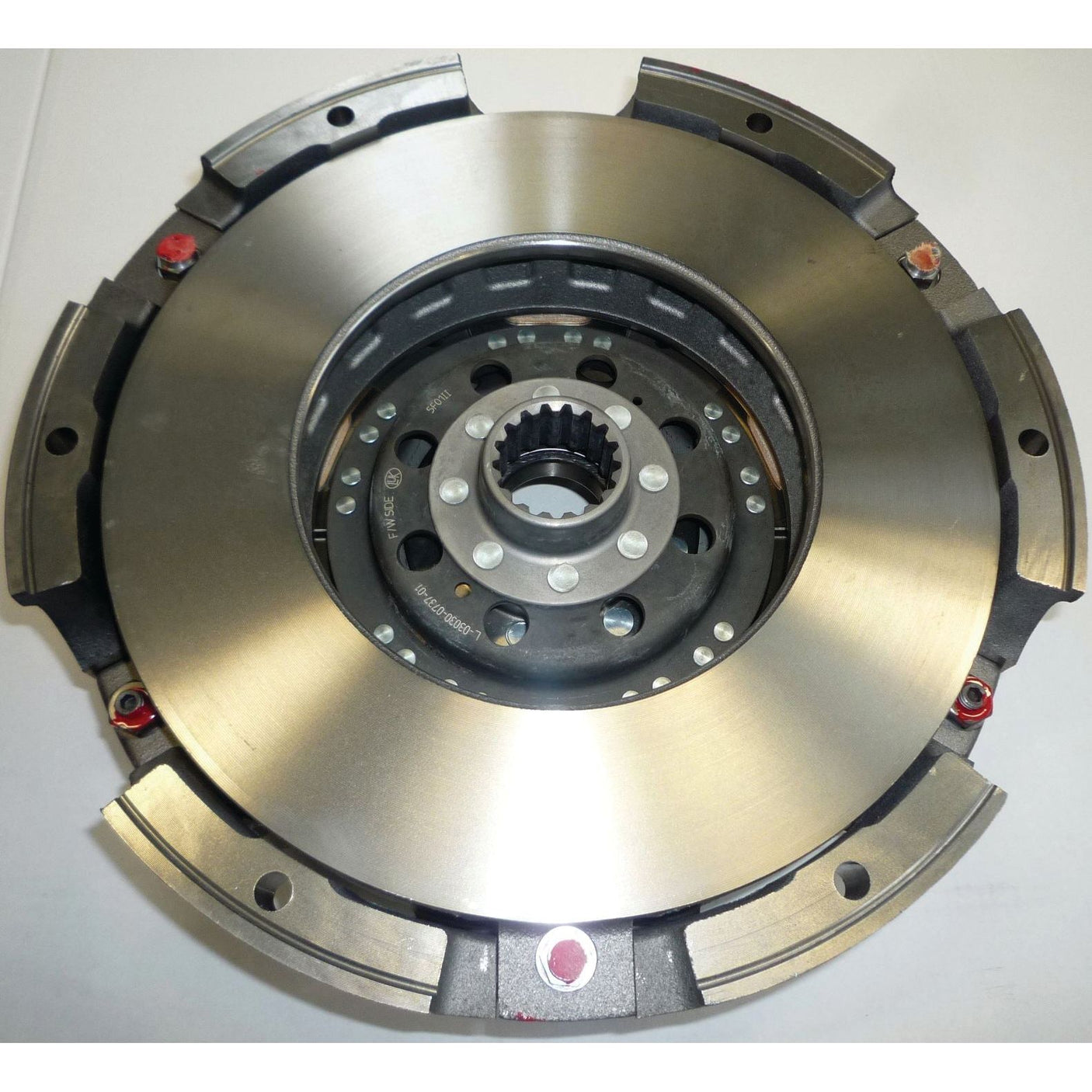 Image of the Clutch Cover Assembly - S.61202 by Sparex, featuring a central hub with gear teeth surrounded by metallic plates and visible hardware, all housed in a robust cast iron housing.