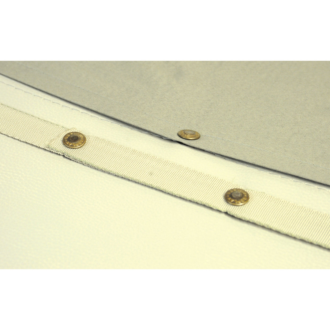 Close-up of a textured white and beige fabric with four small brass rivets along the seam, reminiscent of the high-quality materials used in Sparex Seat Cushion (Sparex Part No. S.612).