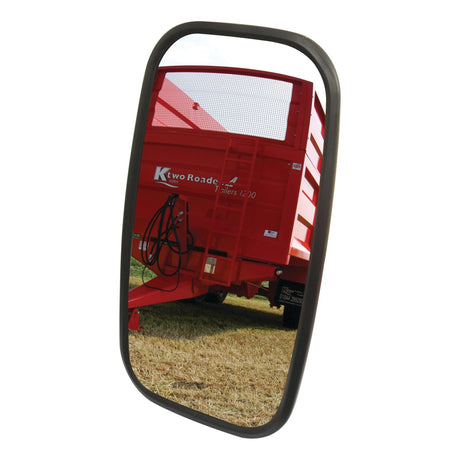 A Sparex Mirror Head, a rectangular convex mirror (320 x 180mm, RH & LH - S.6225), reflects an image of a red trailer against the backdrop of a grassy field.