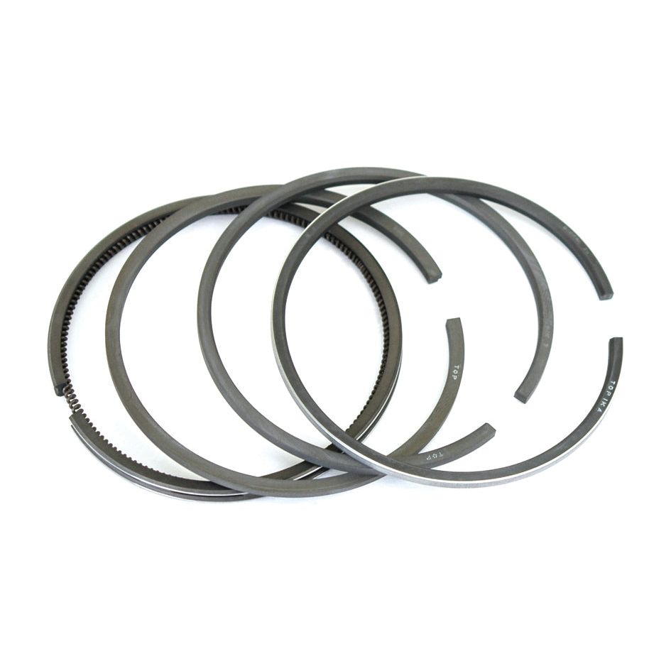 Close-up of four Sparex Piston Ring | Sparex Part No. S.62335, arranged in an overlapping manner on a white background. This ring set is perfect for your Fiat 411R.