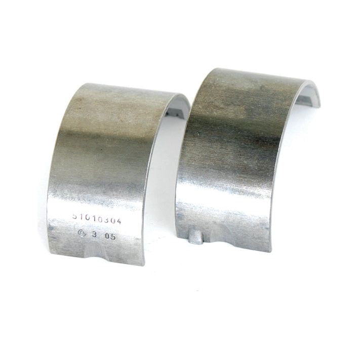 Two metallic bearing shells, marked with serial numbers and placed upright on a white background. These high-quality Conrod Bearing Std. Pair (Sparex Part No.S.64001) are suitable for brands like Sparex and John Deere, ensuring reliable performance in various machinery applications.