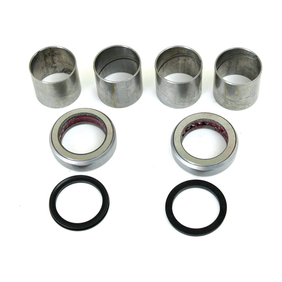 Four cylindrical metal sleeves from the Sparex Spindle Repair Kit (Part No. S.65111), two Ford / New Holland rings with red interiors, and two black circular rings marked 65118 are meticulously arranged in rows on a white background.

