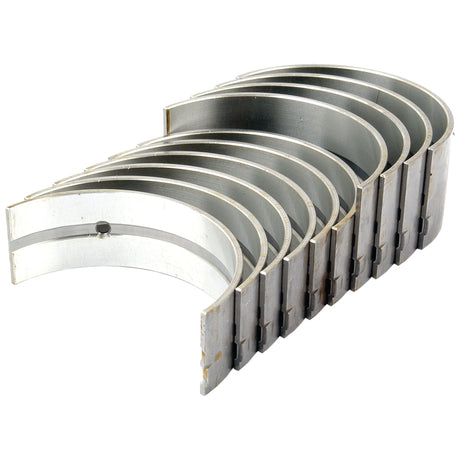 The Sparex Main Bearing Std. (Set) | Sparex Part No.S.65213, designed for Ford New Holland or Case IH machinery, is displayed in a fanned-out stack, highlighting their curved, semi-circular shape.