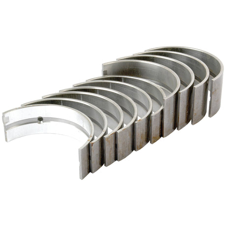 A set of eight Sparex Main Bearing +0.040'' (1mm) (Part No. S.65217) metal engine bearings, ideal for Ford New Holland applications, arranged in a slightly fanned-out stack on a pristine white background.