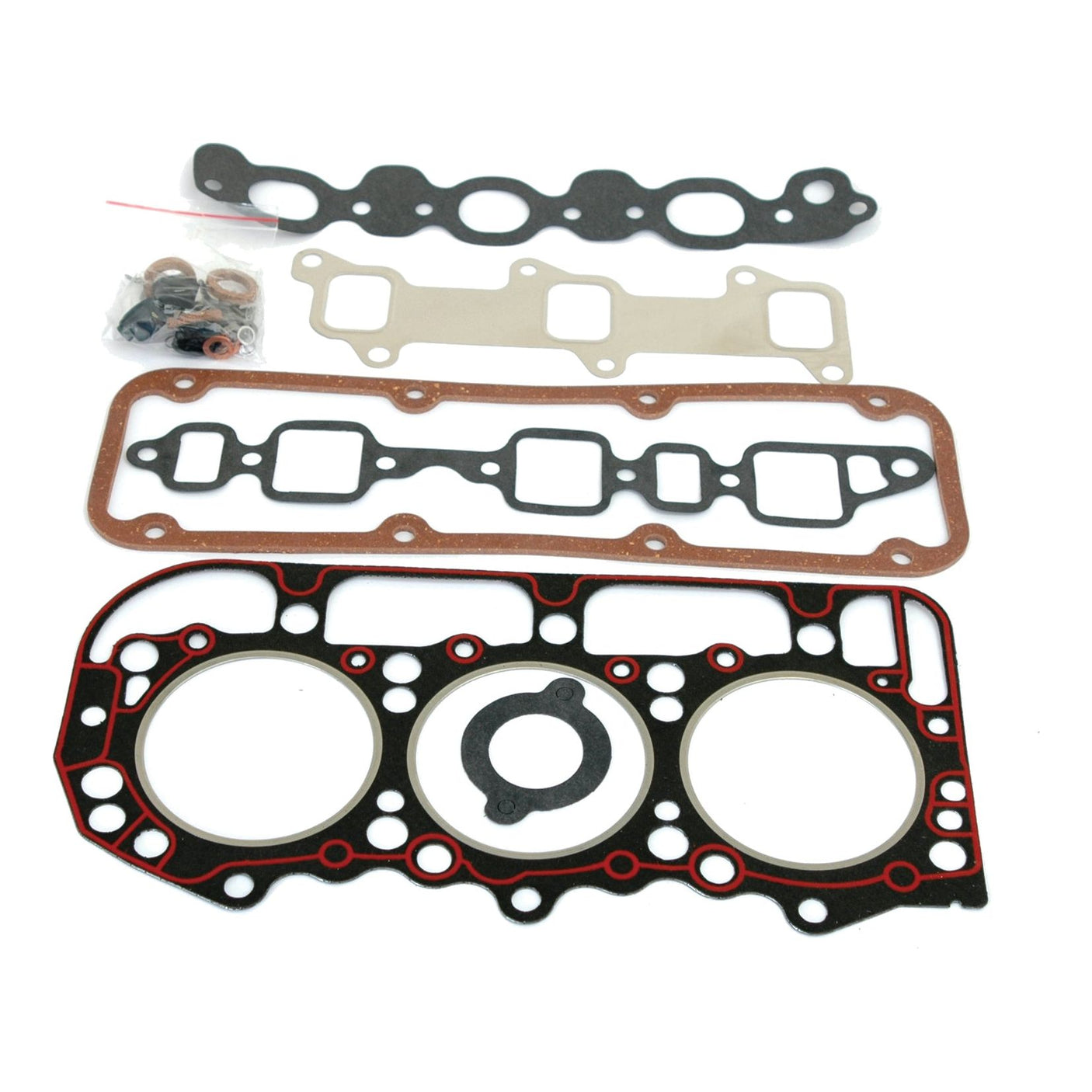 A set of flat, variously shaped gaskets and seals for a Ford engine, neatly arranged in a row. The topmost item includes a small plastic bag containing additional connectors, making the Sparex Top Gasket Set - 3 Cyl. (BSD326, BSD329, BSD332, BSD333) the perfect choice for maintaining your 3-cylinder engine.