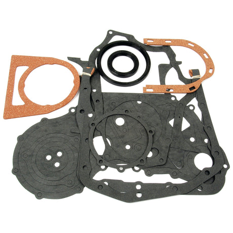 A collection of gaskets and seals in various shapes and sizes, likely intended for automotive or mechanical purposes, is arranged on a white background. Among them is the Sparex Bottom Gasket Set - 4 Cyl. (BSD333, BSD442, BSD444, BSD444T) | Sparex Part No.S.65300, perfect for those working on a Ford engine.