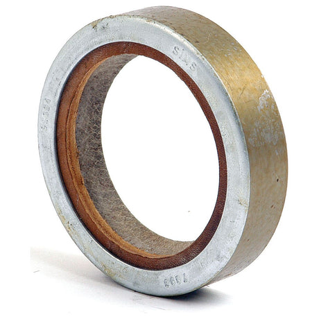 A close-up of a metallic ring-shaped Sparex Imperial Rotary Shaft Seal, 2'' x 2 3/4'' x 5/8'' (Sparex Part No. S.65694), featuring both inner and outer grooves with visible signs of wear and aging.