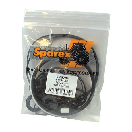 A sealed plastic bag containing a Sparex Seal Kit (Hydraulic Pump) with Part No. S.65784 for Ford 5/7000 tractors and Ford New Holland models, featuring various O-rings and seals visible inside.