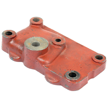 Red metal industrial part with a central threaded hole and four surrounding bolt holes on a flat rectangular shape, often used as the Cover Plate Gasket (Sparex Part No. S.66233) in Ford New Holland machinery (8413910090).