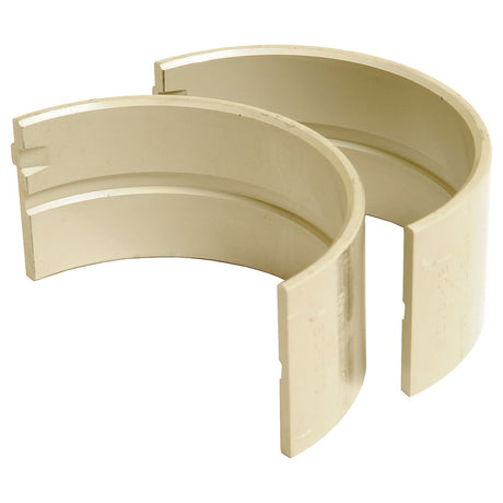 Two semi-circular, beige plastic pipe fittings with grooved edges and notches on one side, compatible with Sparex Engine components (Product Name: Main Bearing Std. (Pair), Sparex Part No.S.67320).