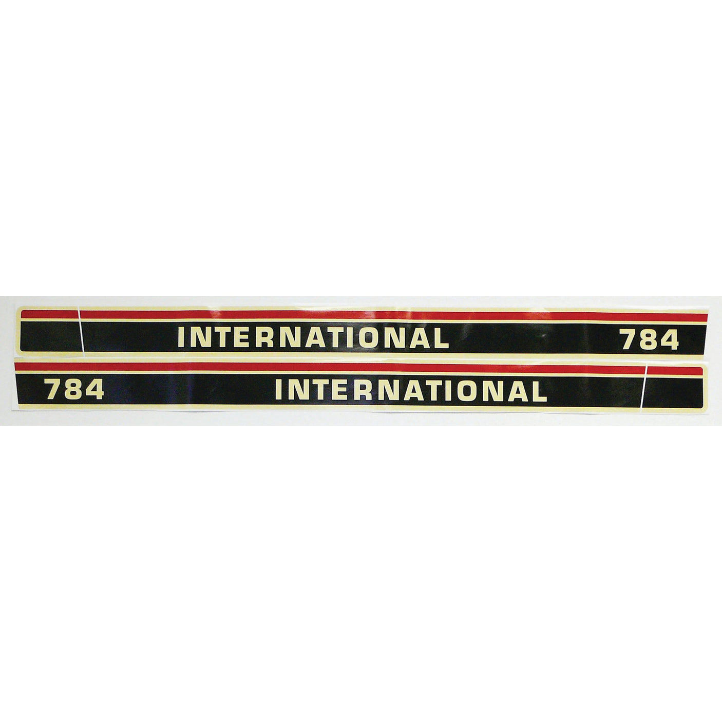 The Sparex Decal Set (Sparex Part No. S.67758) features two rectangular decals with "INTERNATIONAL 784" in black and white text set against a striking red, black, and white background—ideal for any International Harvester enthusiast.