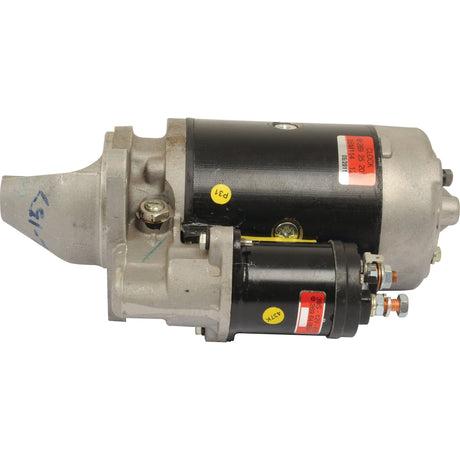 A close-up of the Starter Motor - 12V, 2.7Kw (Lucas TVS) by Sparex (Part No. S.68279), featuring a black cylindrical body and metal components designed for diesel engines, with an attached solenoid.