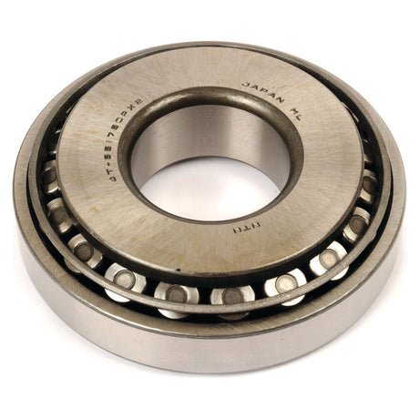 A close-up photo of a cylindrical roller bearing with the text "Japan HL" and "NTN" engraved on the metal surface, similar to the high-quality Sparex Taper Roller Bearing (4T-55175C/55437) - S.68845 from Sparex.