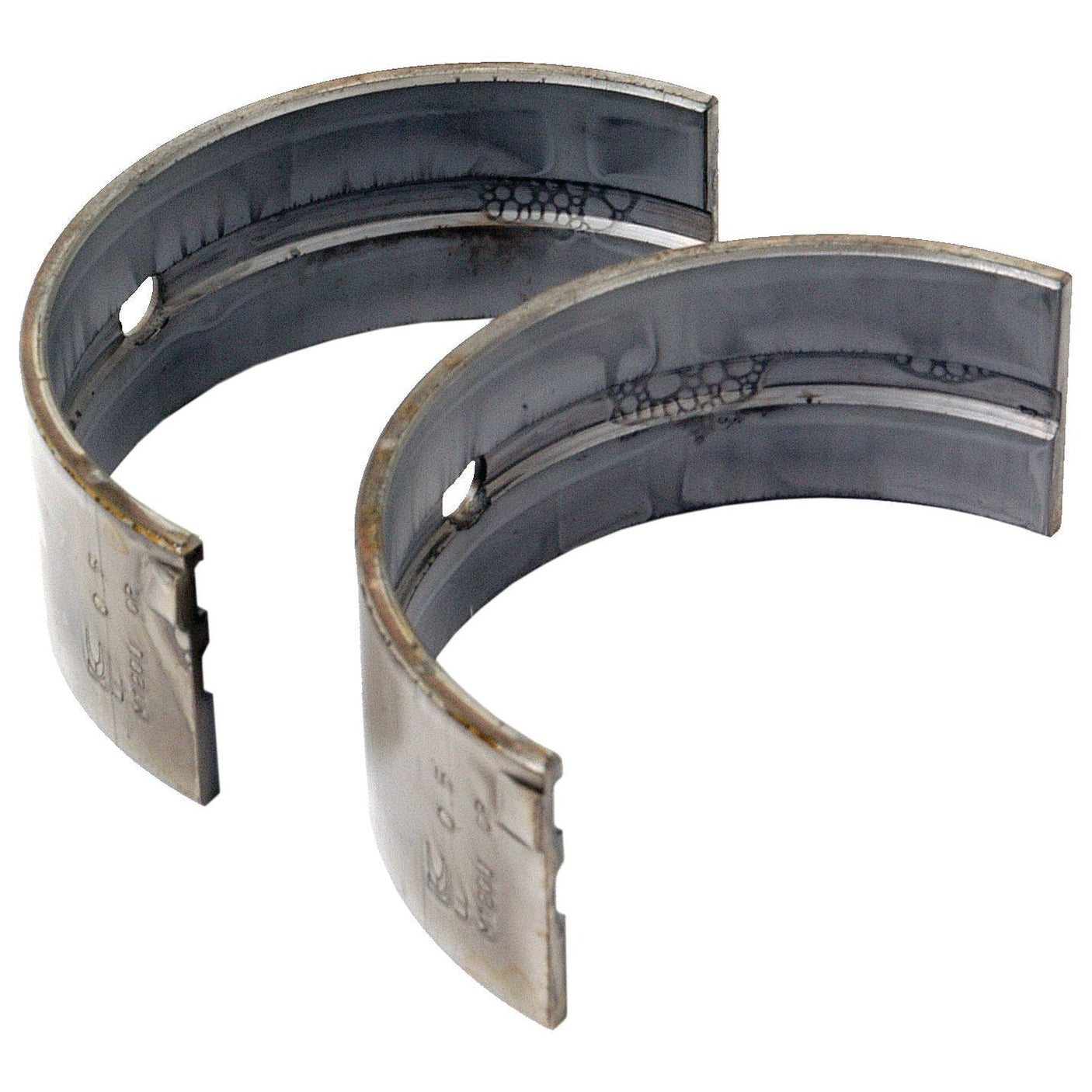 Two Sparex Main Bearings +0.020'' (0.50mm) (Pair), Semi-circular in shape, showing signs of wear and discoloration, identifiable by Sparex Part No.S.69952.