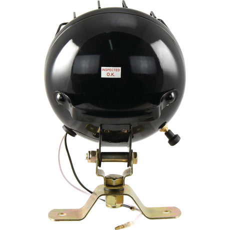 Close-up of a black spherical device labeled "INSPECTED O.K." This device, identified as the Sparex Work Light (Halogen), Round, RH & LH, 12V - S.71199, features wires extending from the back and is securely mounted on a metal bracket.