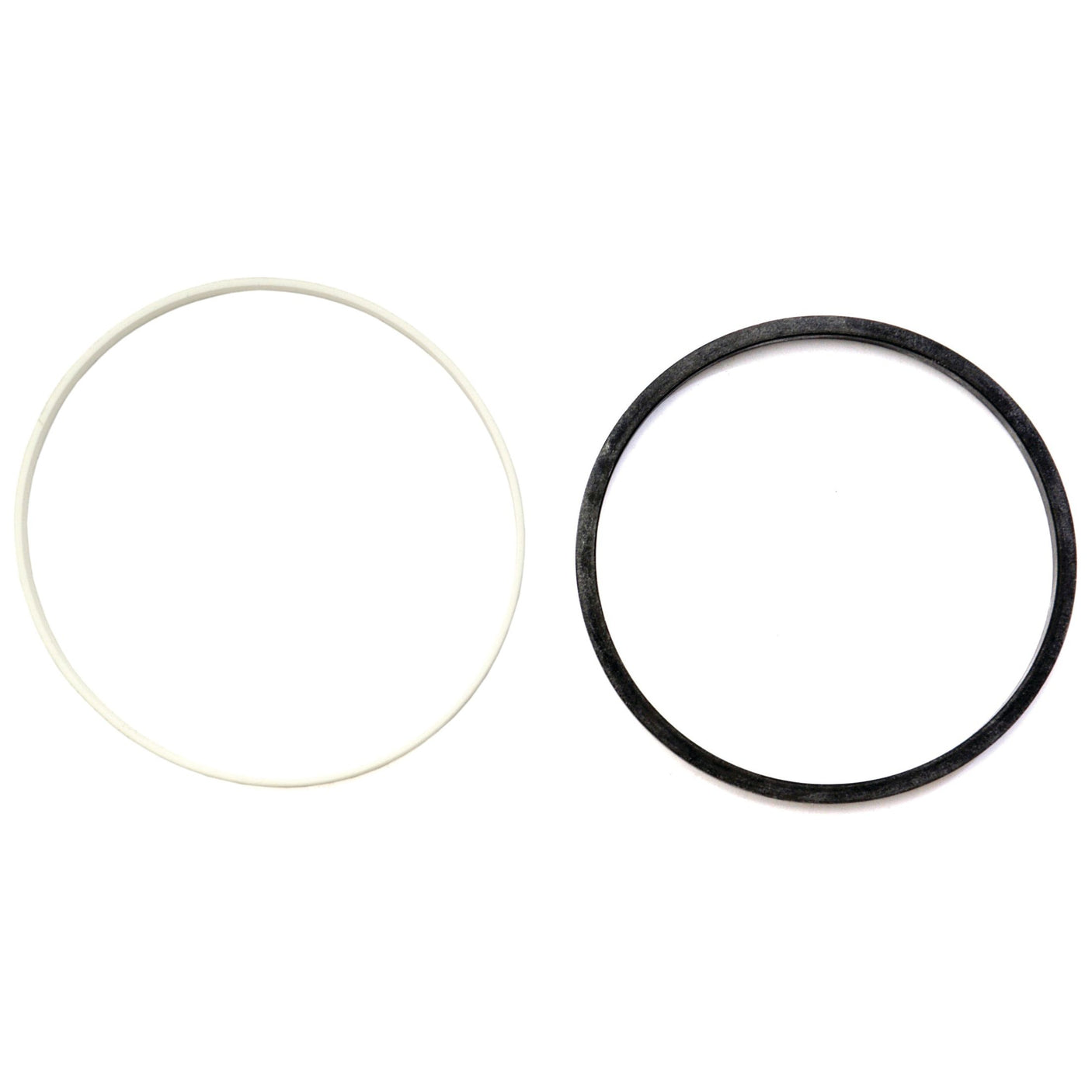 The Sparex S.72452 Seal Kit, featuring one white and one black circular rubber band, is displayed side by side against a white background, creating a striking contrast reminiscent of the iconic colors seen on a John Deere tractor.