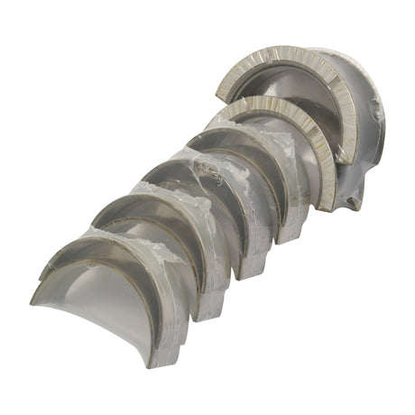 A set of Sparex Main Bearings +0.020'' (0.50mm) (Part No. S.75848), meticulously arranged in a row with partially visible surfaces, each bearing wrapped in transparent plastic, reminiscent of precision-engineered John Deere parts.