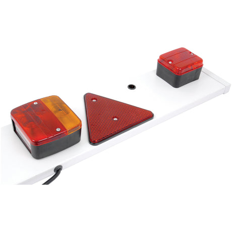 The Sparex Lighting Board (Halogen), 1.8m, includes two rectangular halogen lights featuring amber and red lenses for brake, tail, and indicator signals. It also has a red triangular reflector in the center. The board supports five functions: brake, tail, indicator, number plate light, and fog light at 12V - S.7904.