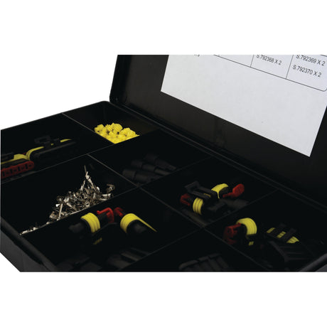 A Sparex Assorted Superseal Block Connectors (Handipak 228 pcs.) - S.792379, a black storage box with eight compartments containing various small components, including yellow and black connectors, metal parts, and printed labels.