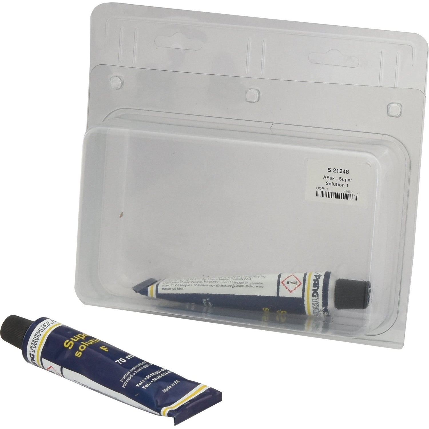 A small tube of APak - Super Solution 1 (Sparex Part No. S.21248) is partly out of its clear, rigid plastic packaging, alongside a few tube tyre patches. A label with barcodes is attached to the packaging, bearing the Sparex brand name.