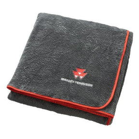 A folded, dark grey fleece-feel blanket with a red trim featuring the Massey Ferguson logo and name in the center. This cozy product is known as the Massey Ferguson - Old Logo Blanket - X993412005000 by AGCO.