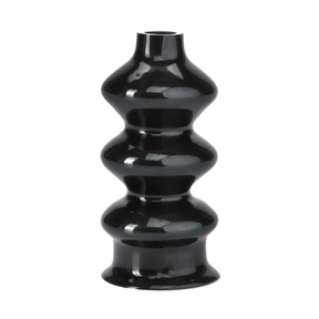 A black, glossy ceramic vase with vertically ribbed texture and undulating curves, featuring a narrow opening at the top, evokes the sleek design seen in vintage AGCO Massey Ferguson tractor parts like the 3901461M1 boot.